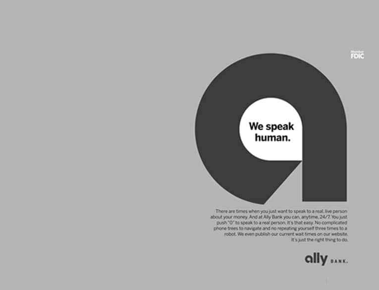 Black and white 2014 print ad photo of a large Ally lowercase A against a solid background, with the slogan ‘we speak human’ written inside the opening of the A