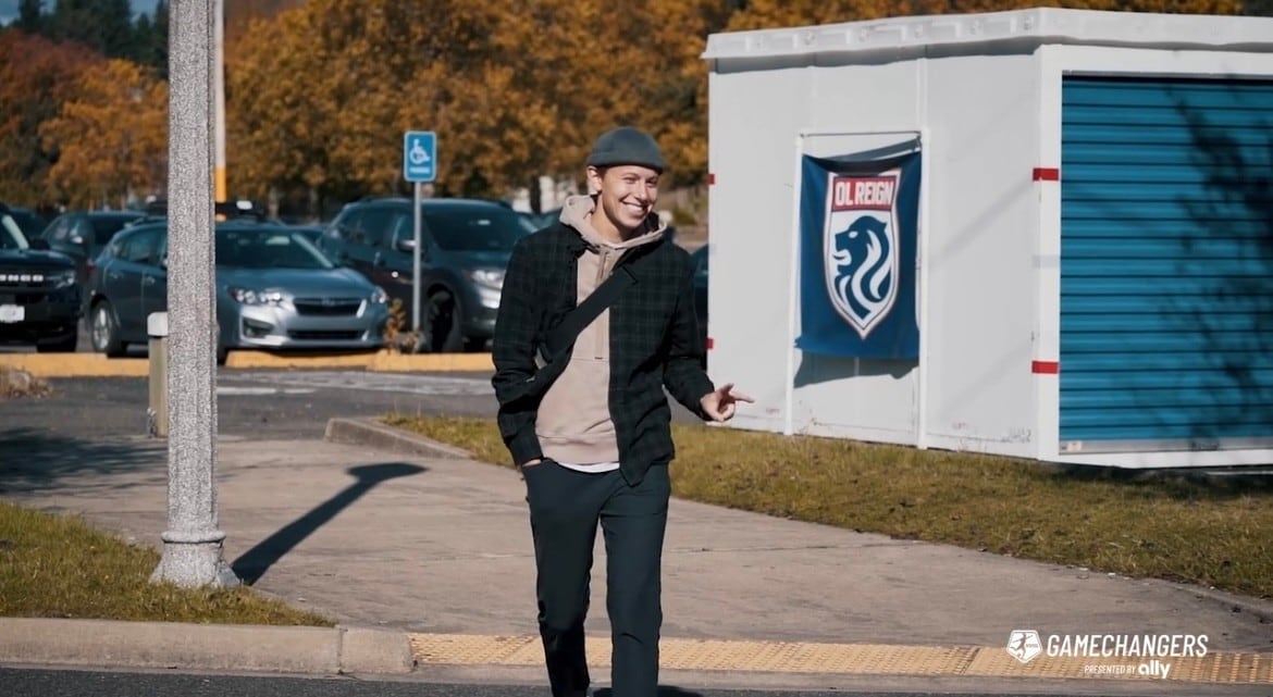 Professional soccer player, Quinn, walks into training as a member of the NWSL