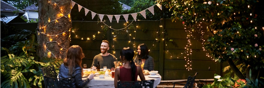 A group of friends having a dinner party outdoors.