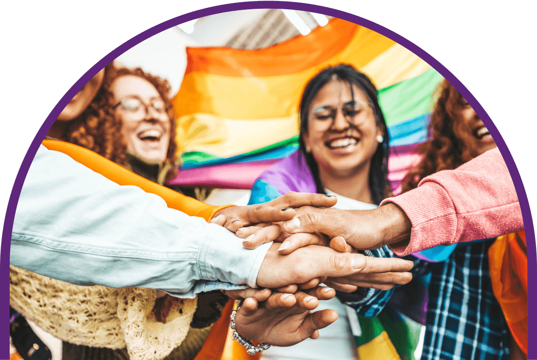A colorful group of hands meet in the center of a celebratory cheer.