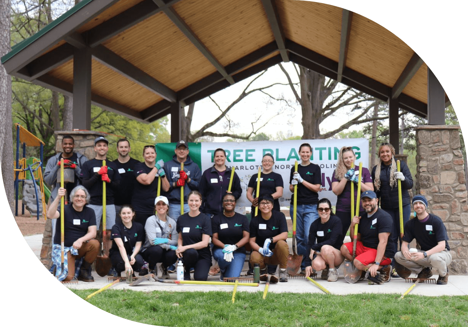 a group of Ally employees participating in a tree planting volunteer event.