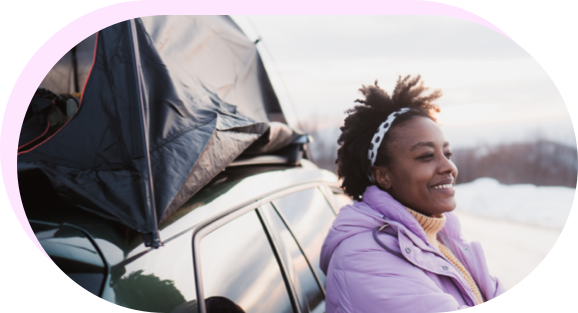 Woman in coat leaning against car