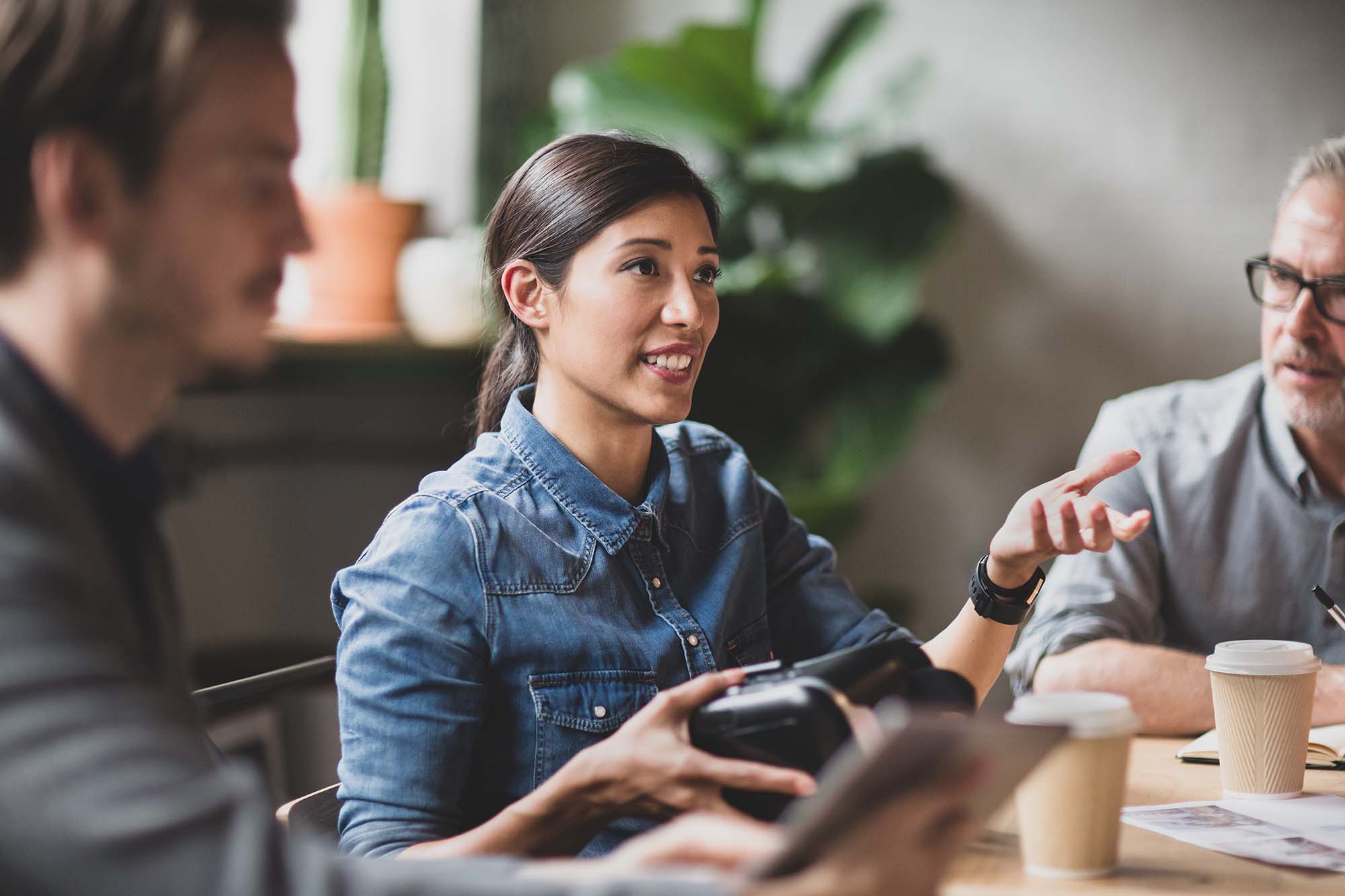 A woman having coffee with her co-workers.