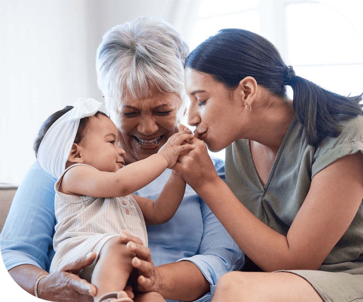 a family moment where members of three different generations share a sweet moment