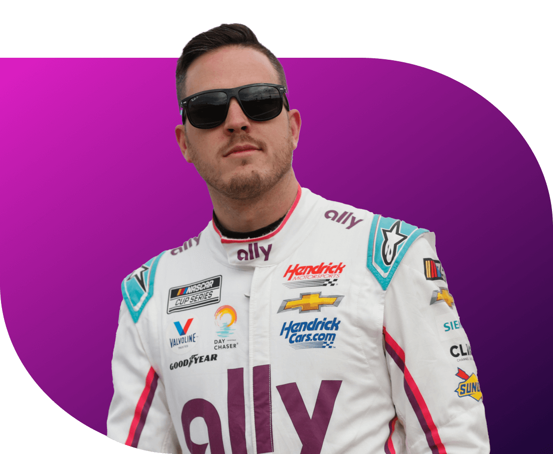 Alex Bowman, wearing sunglasses and the white Ally firesuit, stares into the distance.