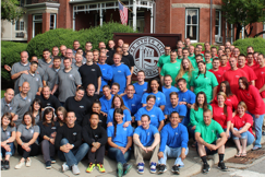 A large team of Ally volunteers pose outdoors