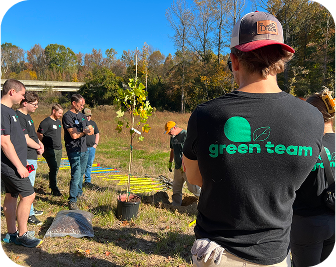 a group of employees planting a tree