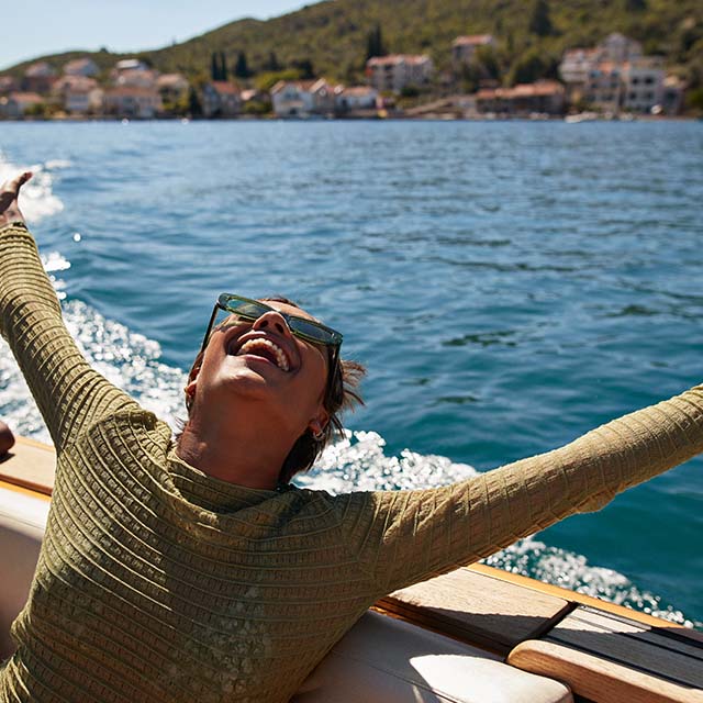 Happy woman on a boat while on vacation