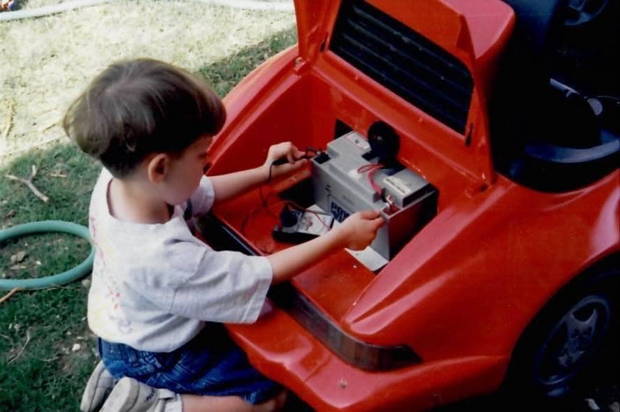 Young Alex Bowman plays with the battery in his toy truck