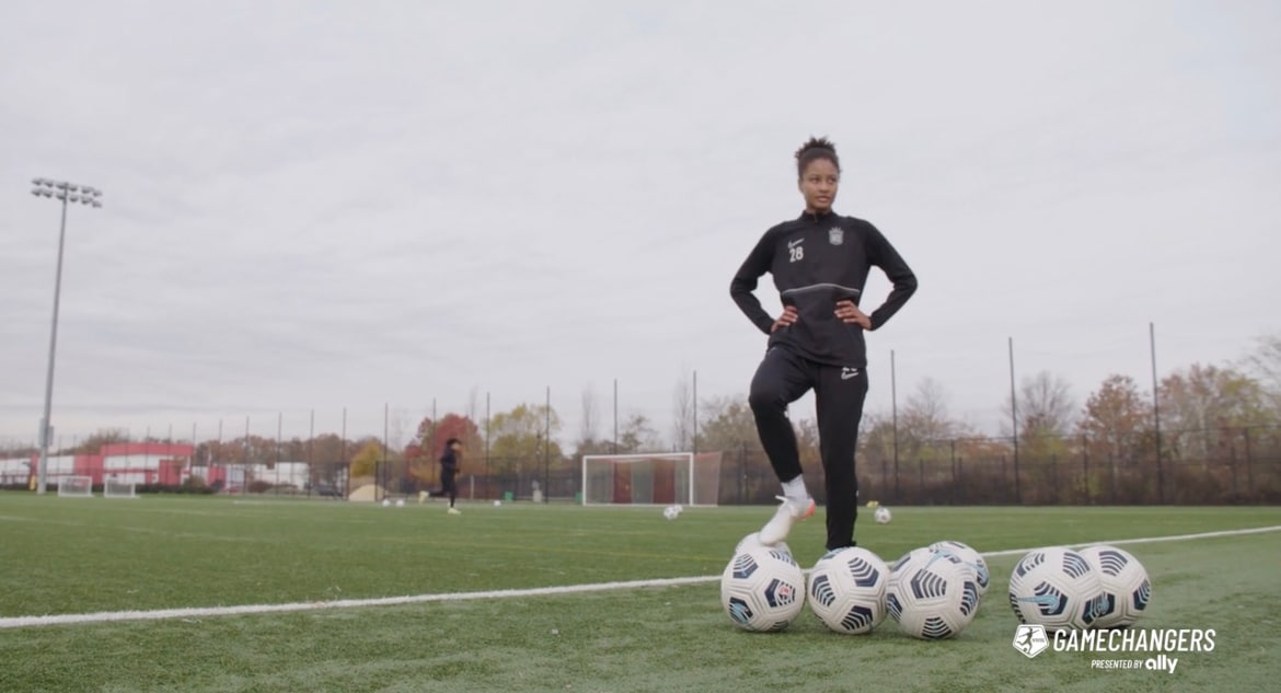 Soccer player, Imani Dorsey, poses with soccer balls as she works for equality