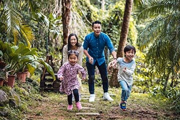 Two kids running in front of their parents