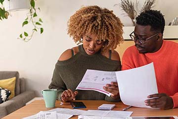 a young couple going over their finances together at home