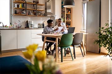 young couple doing research at the kitchen table