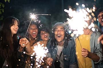 Friends celebrating the new year with sparklers.