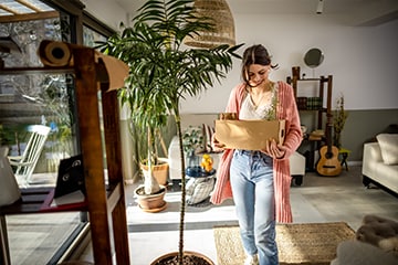 Woman moves houseplants into a new home