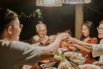 A multigenerational family celebrates over dinner