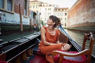 woman on vacation sitting in a gondola
