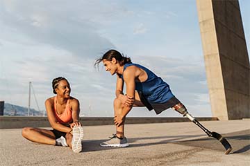 Two people stretch before a run