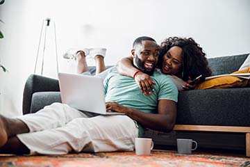  A couple looks over their investment accounts at home on a laptop