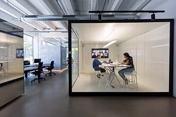 Man and woman work in a modern, open office space