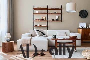 Modern living rom with a beige sofa, coffee table, shelf with décor, pendant lamp and small decorations.