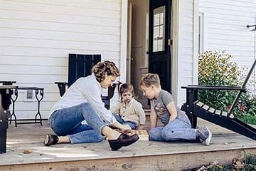 Family playing games on front porch at home