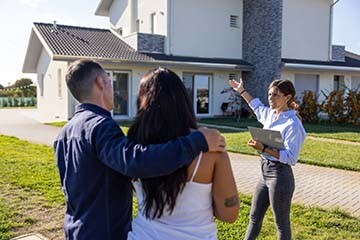 Couple viewing a home for sale with real estate agent