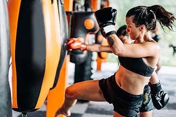 A woman doing an intense punching bag workout