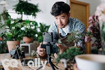 A young male botanist sets up his phone and camera before recording an online tutorial.