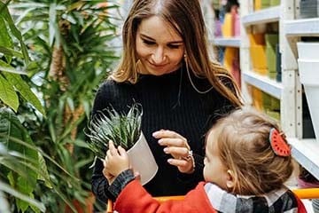 Woman plant shopping with her daughter