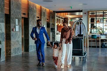 Family walking through a hotel with their luggage